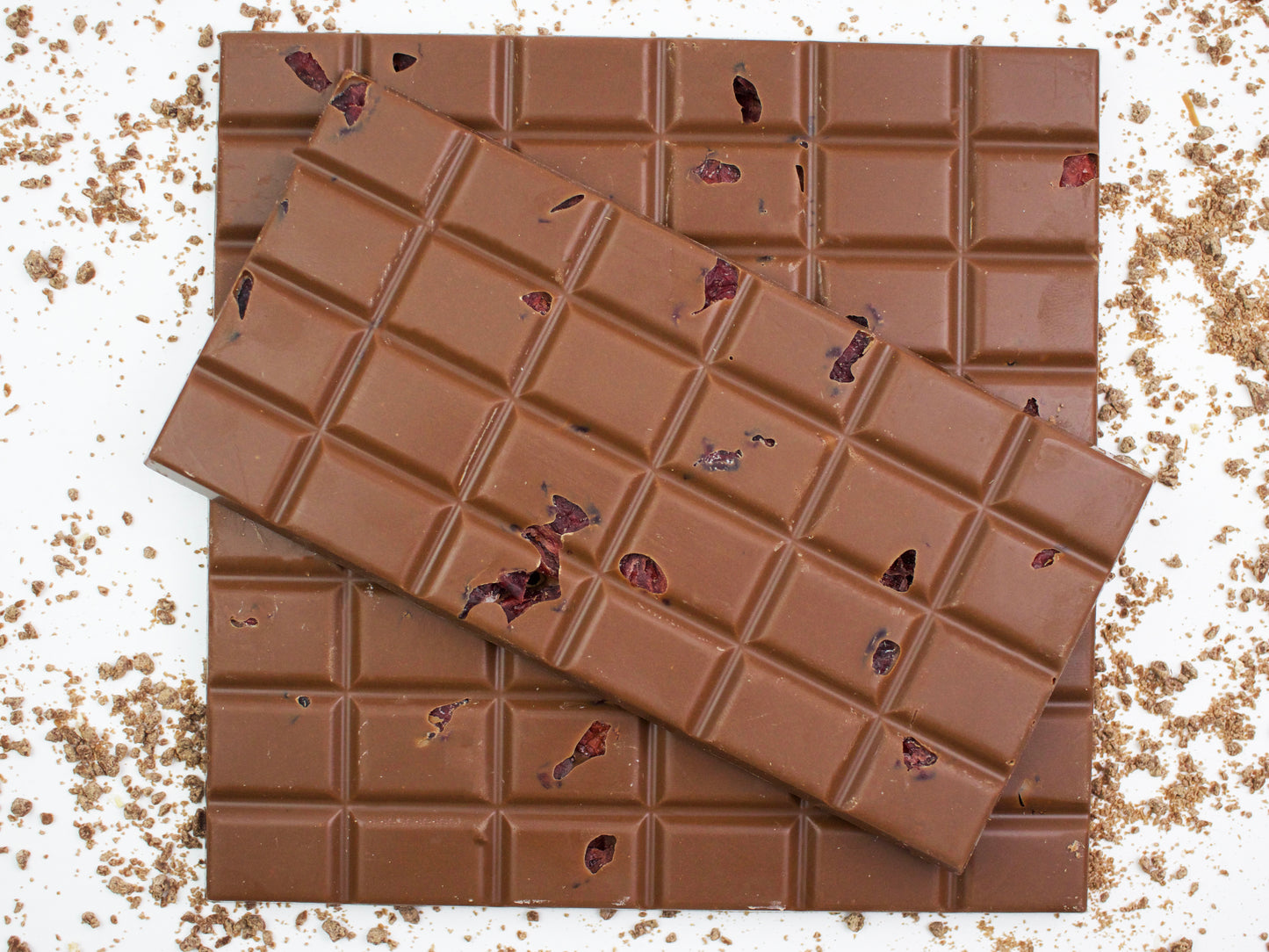 image shows 3, hand made milk chocolate bars embedded with cranberries and flavoured with orange.