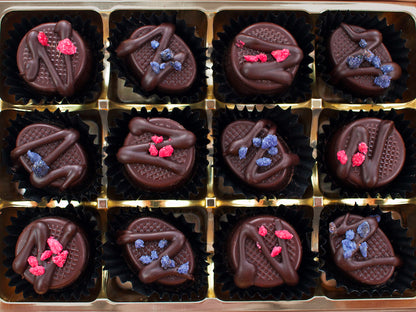 image shows a collection of 12 chocolates containing 6 each of rose creams and violet creams