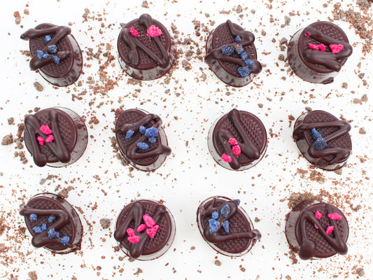 image shows individual hand made rose cream and violet cream chocolates.