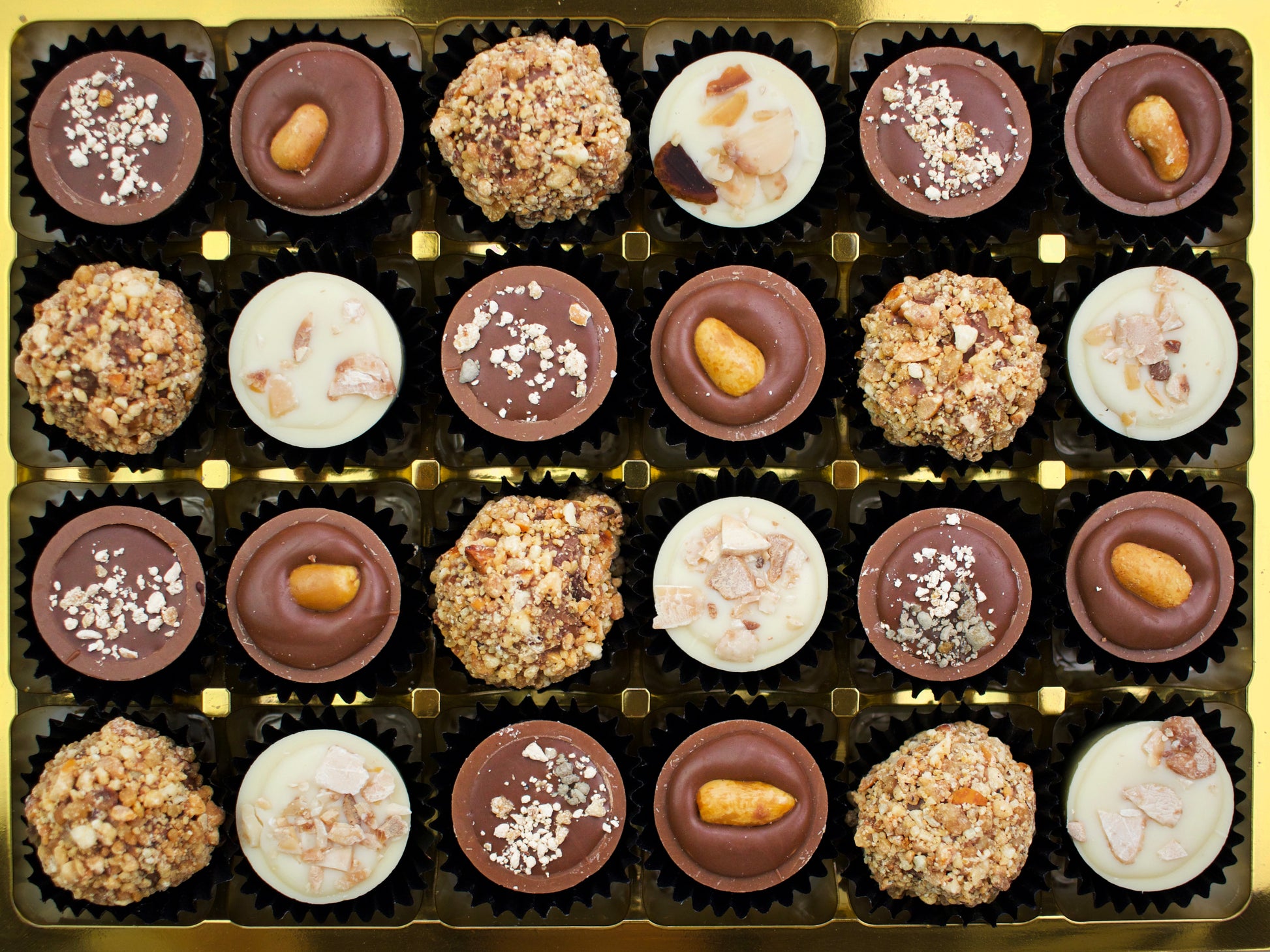 image shows a gift selection of 24 nut butter and caramel filled chocolates