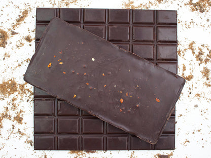 image shows 3, 100g hand made dark chocolate chilli bars, 2 viewed from the top and 1 viewed from the underside showing chilli flakes