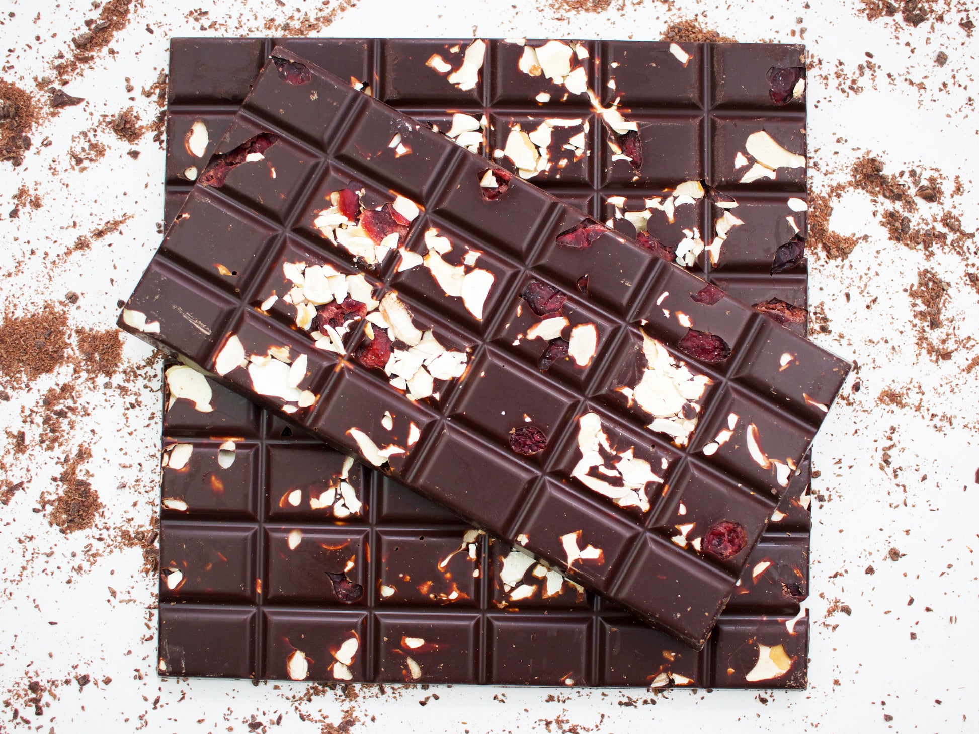 image shows 3, 100g hand made bars of dark chocolate embedded with cranberries and pieces of almonds.ark cho
