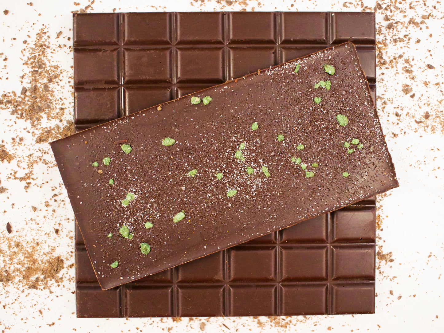 image shows 3, 100g hand made dark chocolate peppermint bars, two showing break up sections and one showing crystallised mint leaf decoration.