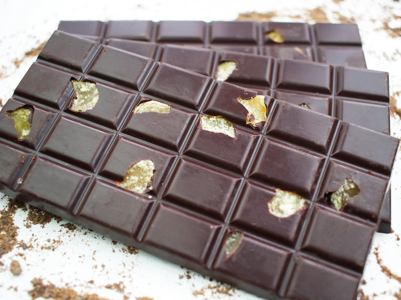 image shows 3, 100g hand made dark chocolate bars embedded with pieces of crystallised ginger and flavoured with lime