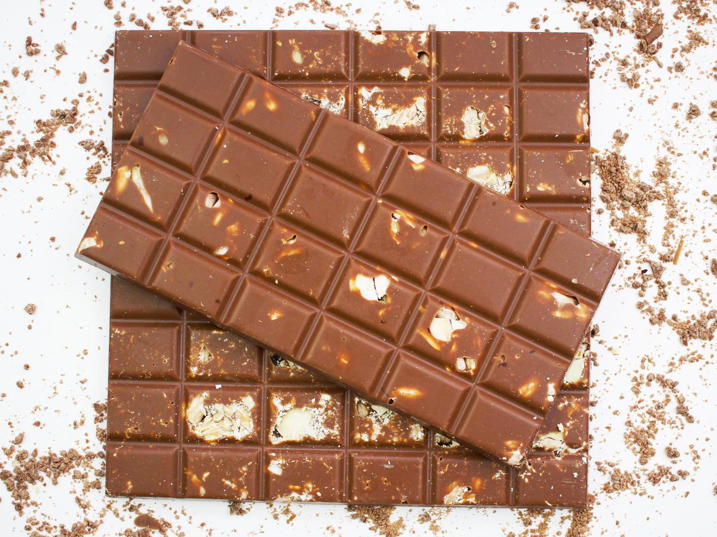 Image shows 3, 100g hand made milk chocolate bars embedded with toasted almonds.