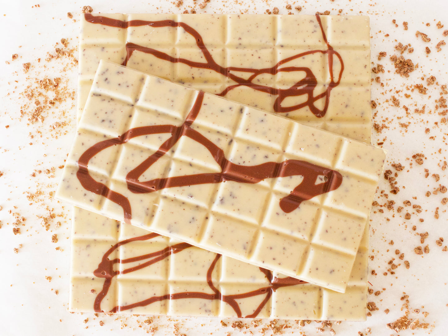 Image shows 3, 100g white chocolate, hand made bars, containing natural coffee grains and drizzled with milk chocolate.