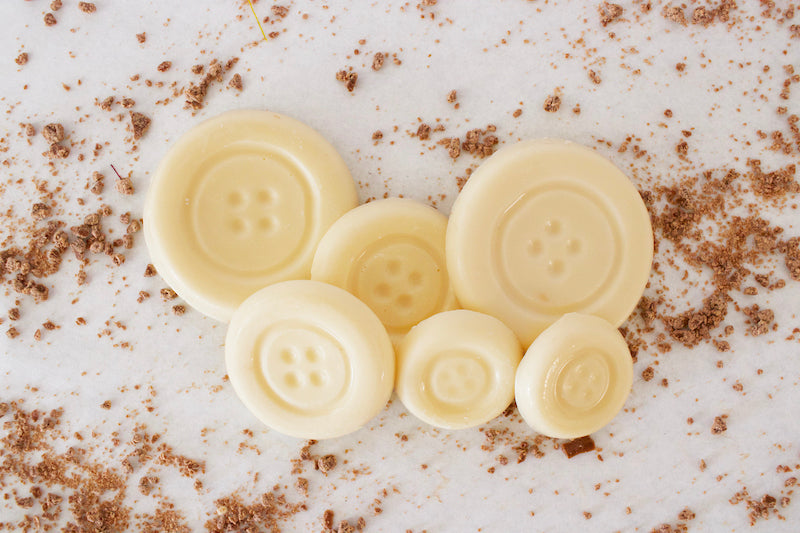 image shows white sugar free chocolate button shaped chocolates.