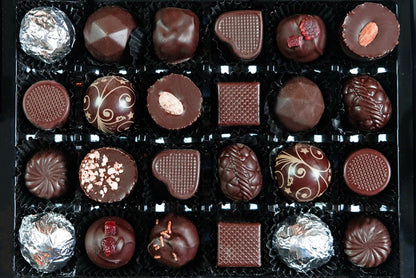 image shows a selection box of 24 vegan chocolates