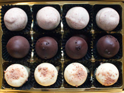 image shows a box of hand made truffles, 4 each of berry gin, salted caramel vodka and whisky