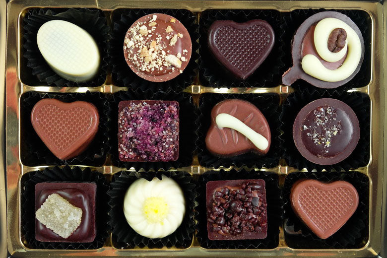 image shows a selection of 12 hand made chocolates from The Pod Chocolates Original Collection.