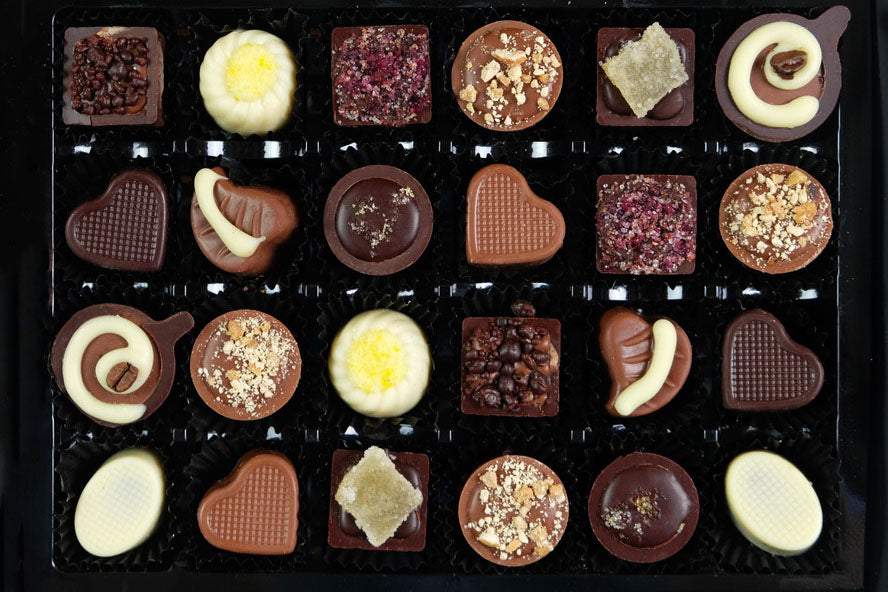 image shows a box of 24 hand made chocolates from The Pod Chocolates Original Collection. 