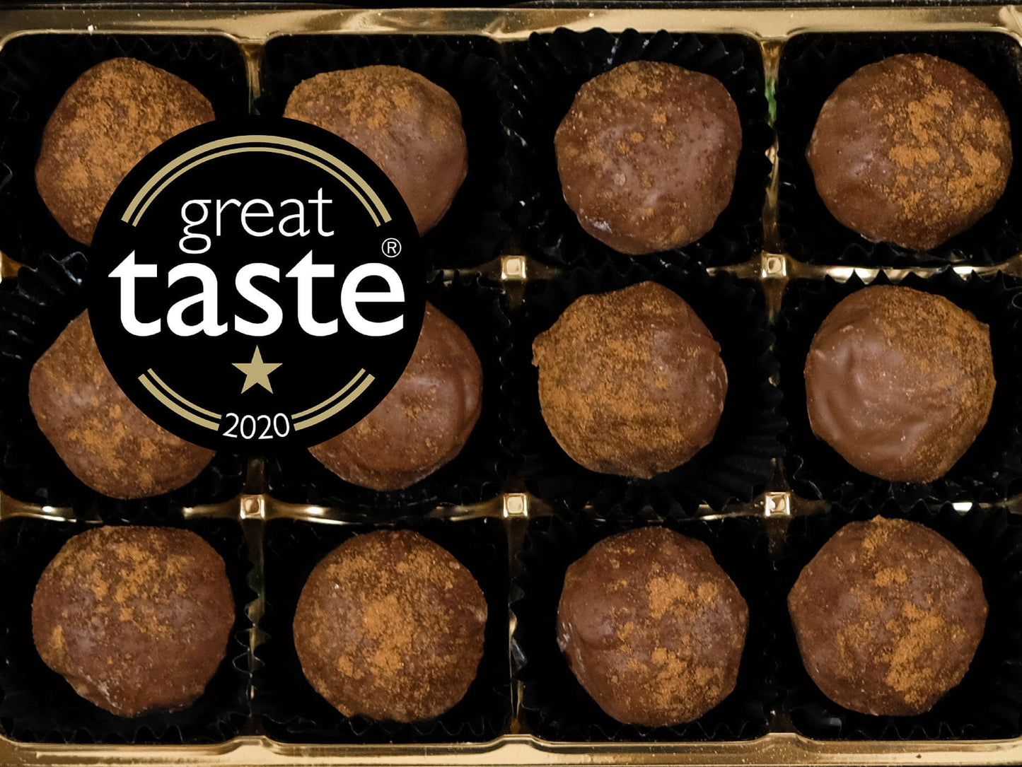 Image shows a box of 12 hand made Norfolk Apple dairy cream truffles with the Great Taste logo