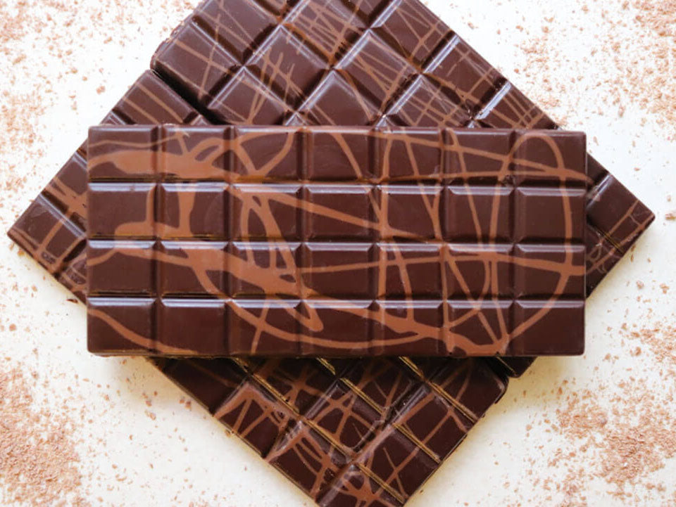 image shows 3, 100g dark chocolate orange flavour bars drizzled with milk chocolate