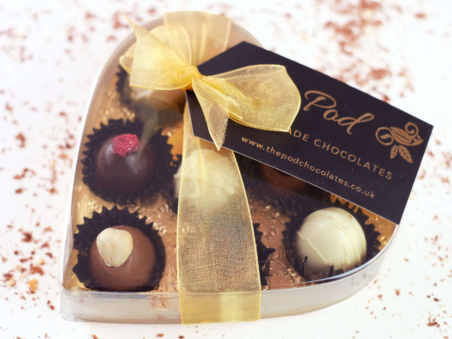image shows a heart shaped gift box of 8 sugar free chocolates tied with a gold box