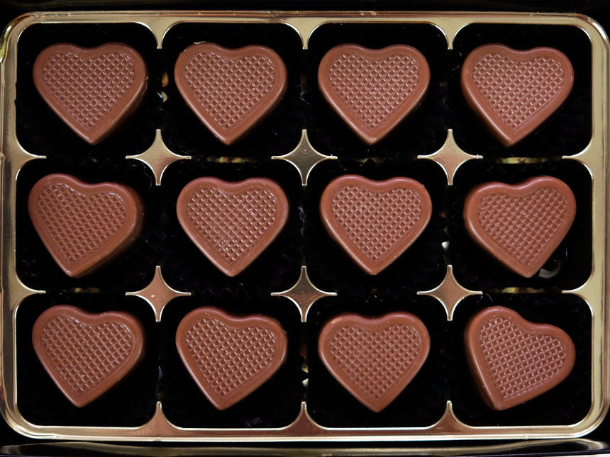 Image shows a gift box of 12 hand made Milk Caramel filled milk chocolate hearts.
