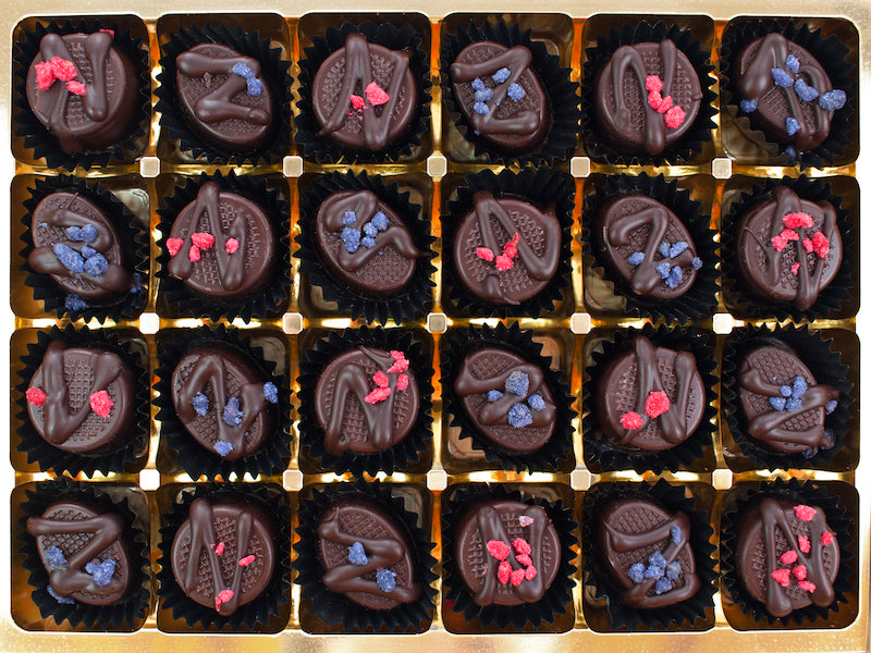 image shows a collection of 24 chocolates containing 12 each of hand made rose creams and violet creams