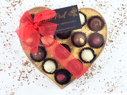 image shows a gift box of 15 sugar free chocolates tied with a red bow