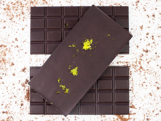 image shows 3, 100g vegan dark chocolate lemon bars, one with lemon sugar sprinkle on the back.