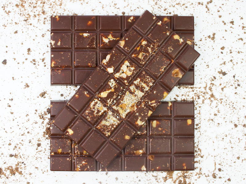 image shows 3, 100g hand made vegan milk chocolate bars, embedded with crushed hazelnuts