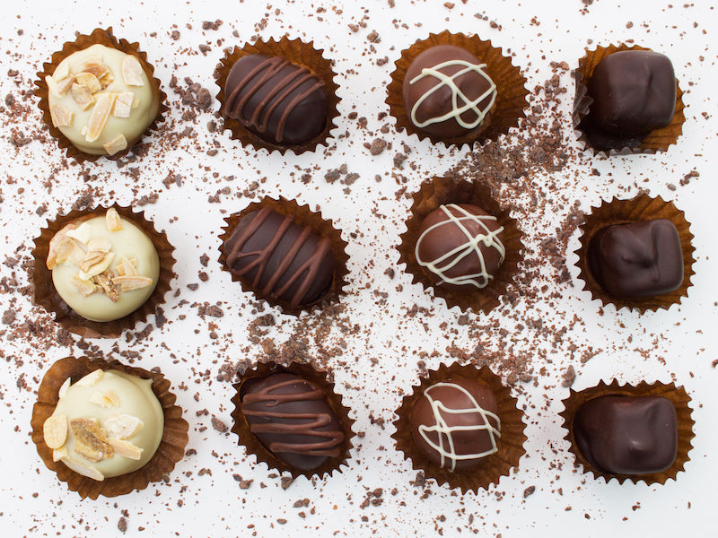 image shows individual vegan white, milk and dark marzipan chocolates.